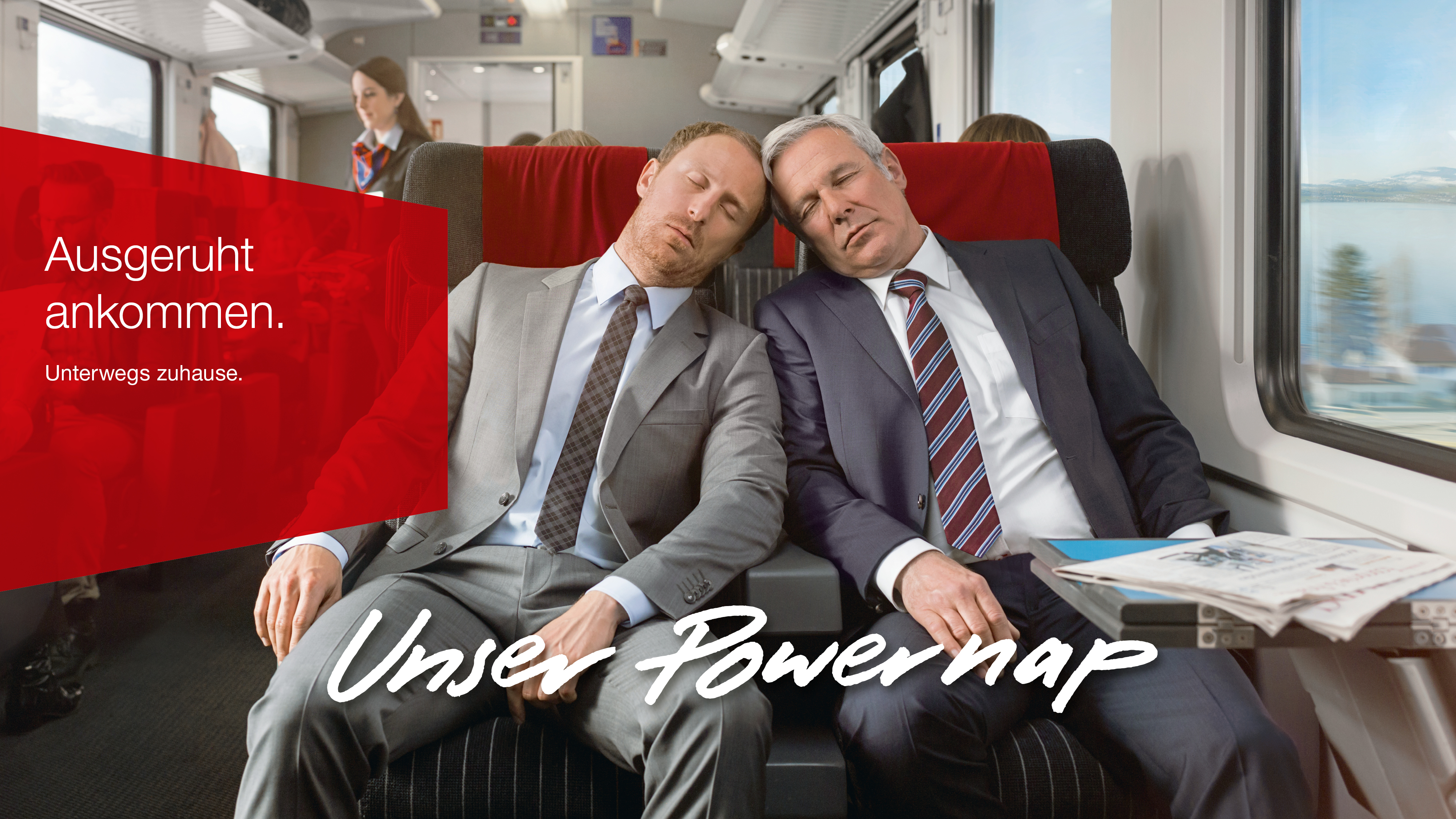 Two men in suits sleeping on the train